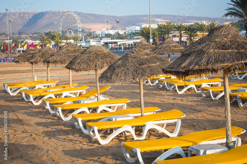 Beach loungers and umbrellas on the sea. Main beach in Agadir city located on the shore of the Atlantic Ocean.Morocco.