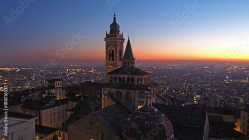 Bergamo, Italy. The old city. Aerial view of the Basilica of Santa Maria Maggiore and the chapel Colleoni during the sunset. In the background the Po plain © Matteo Ceruti