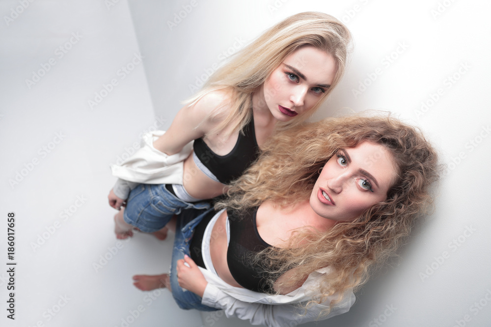 view from the top. two modern girls looking at the camera view from the top. two modern girls looking at the camera