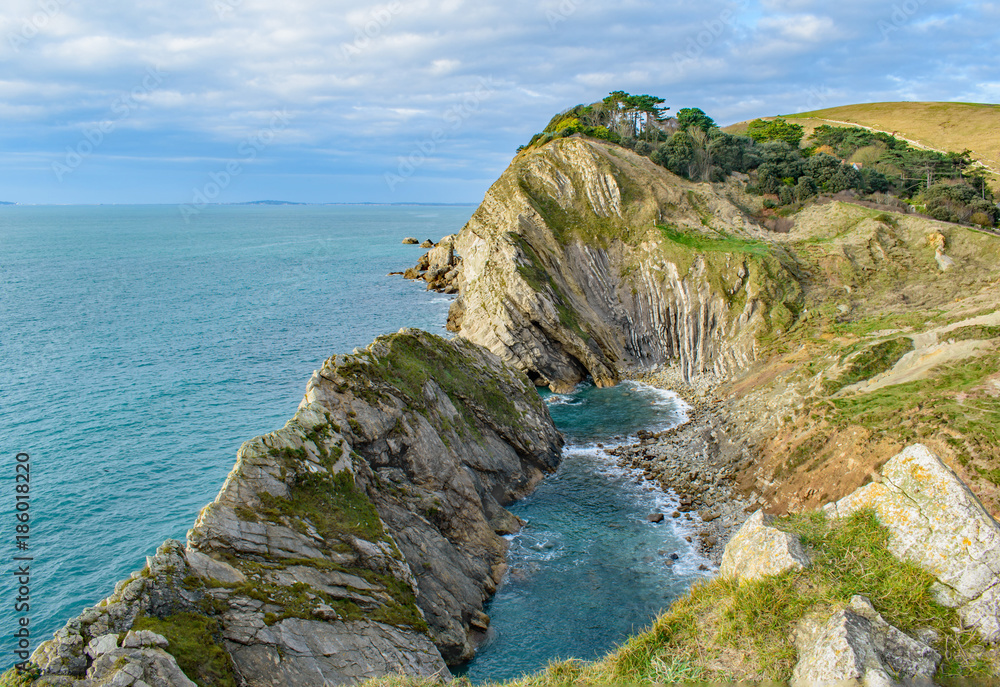 Dorset Coast Clifftop view near Lulworth Cove down to blue pools on the beach