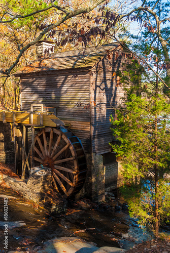 Grist Mill and the creek in the Stone Mountain Park in sunny autumn day, Georgia, USA
