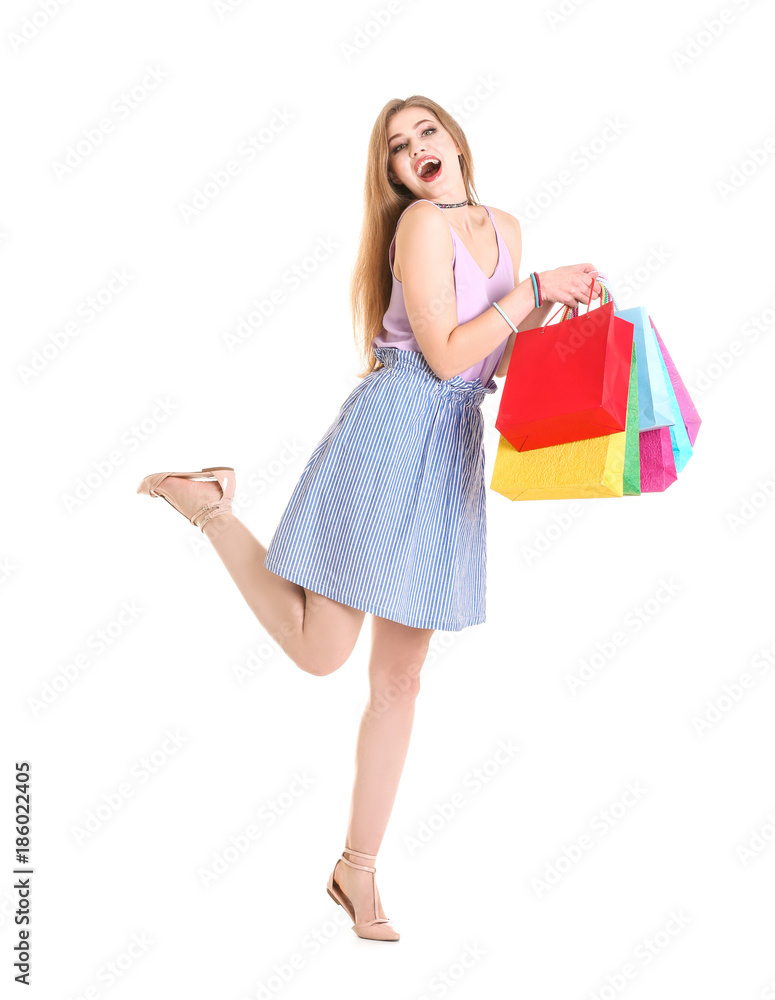 Excited young woman with shopping bags on white background