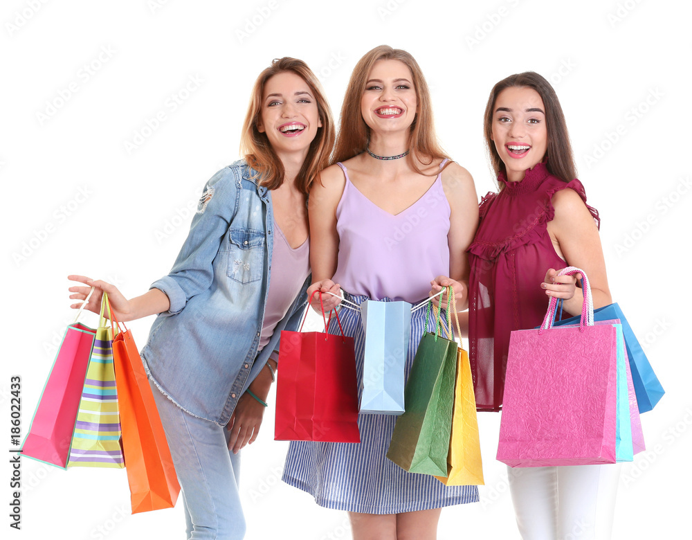 Happy young women with shopping bags on white background Happy young women with shopping bags on white background