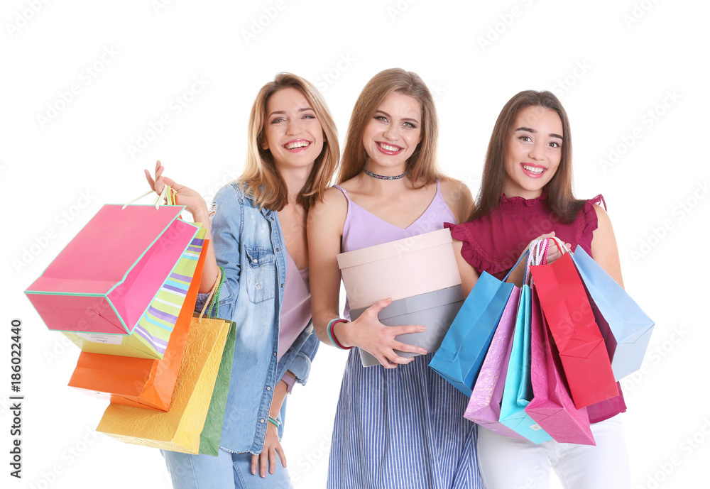 Happy young women with shopping bags and boxes on white background Happy young women with shopping bags and boxes on white background