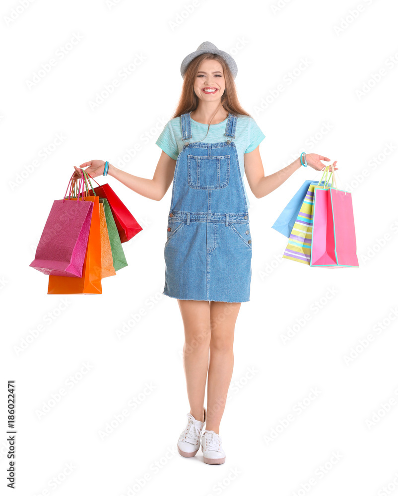 Happy young woman with shopping bags on white background