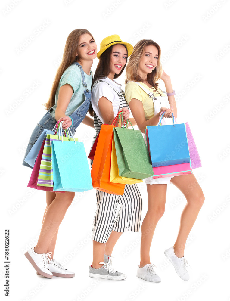Happy young women with shopping bags on white background Happy young women with shopping bags on white background