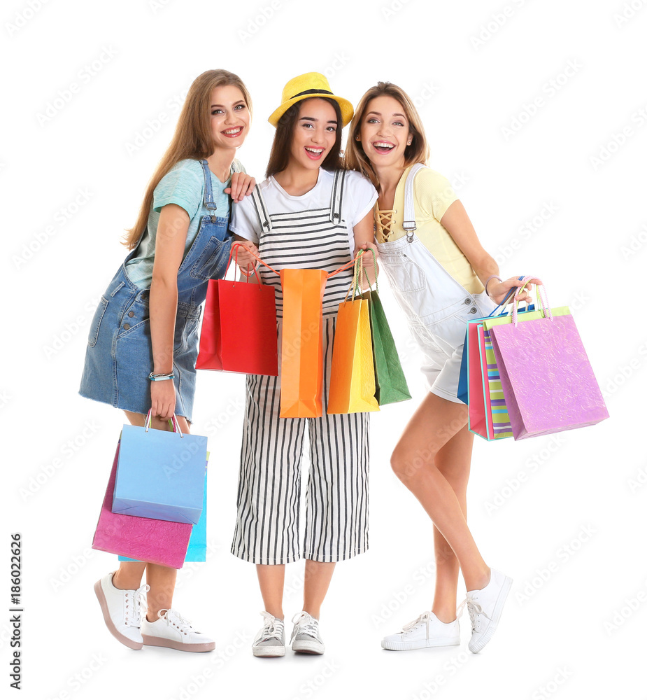 Happy young women with shopping bags on white background Happy young women with shopping bags on white background