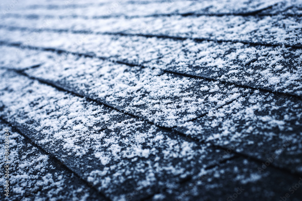 a bit of snow on asphalt shingles a bit of snow on asphalt shingles