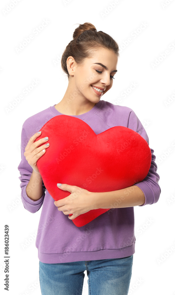 Romantic young woman with heart-shaped pillow on white background Romantic young woman with heart-shaped pillow on white background