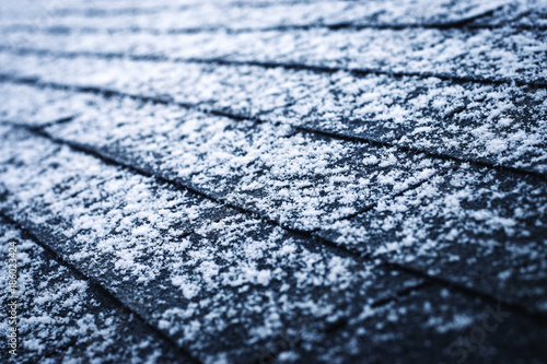a bit of snow on asphalt shingles