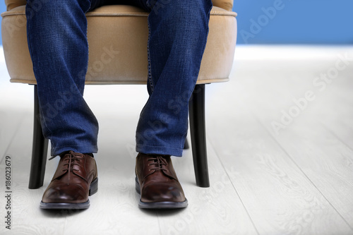 Man in elegant leather shoes indoors, closeup