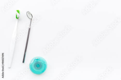 Healty teeth. Toothbrushes and dental mirror on white background top view copyspace