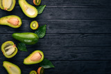 Avocado and kiwi on a wooden background. Top view. Free space for your text.