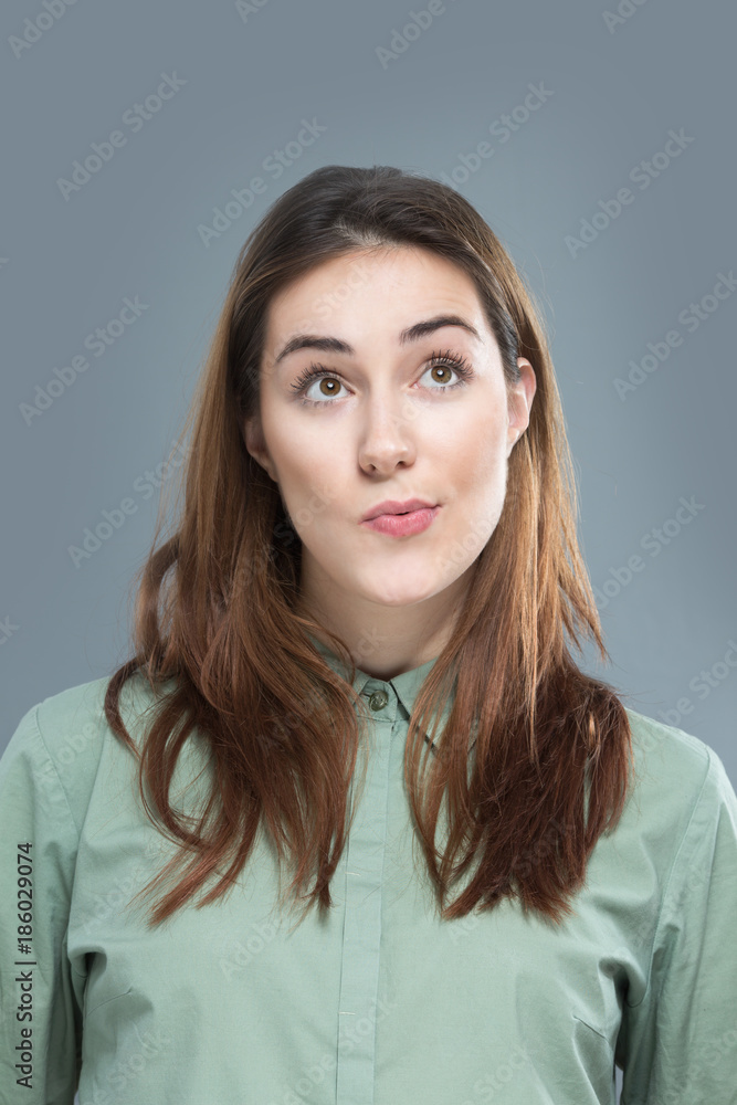 Portrait of beautiful young woman thinking