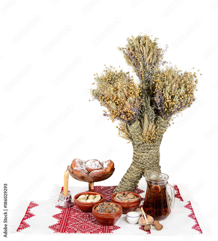 Traditional Christmas treat of the Slavs on Christmas eve. Slavic food kutia, uzvar, varenyky, pyrogy, muchrooms, candle and didukh on white background