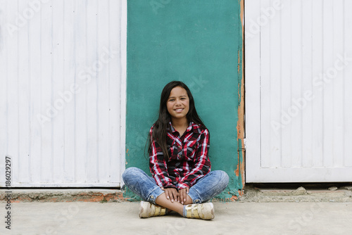 Portrait of cute latino girl in the street.