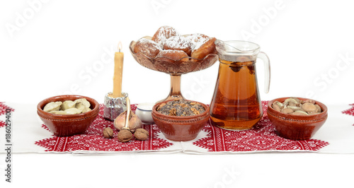 Obraz na płótnie Traditional Christmas treat of the Slavs on Christmas eve. Slavic food kutia, uzvar, varenyky, pyrogy, muchrooms, candle on white background w salonie