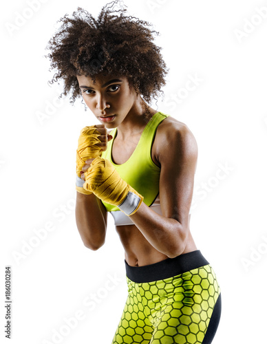 Boxer in defensive stance looking fierce. Photo of strong african girl posing in silhouette on white background. Strength and motivation.