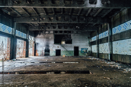 Ruined interiors of abandoned industrial hall. Charred walls
