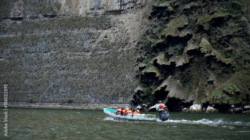 driving on boat, touristic boat riding near canyon wall with natural cascade form, tour in the Sumidero Canyon - Chiapas, Mexico
