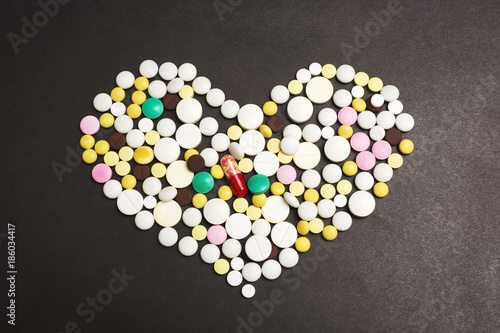The heart made of pills on dark background