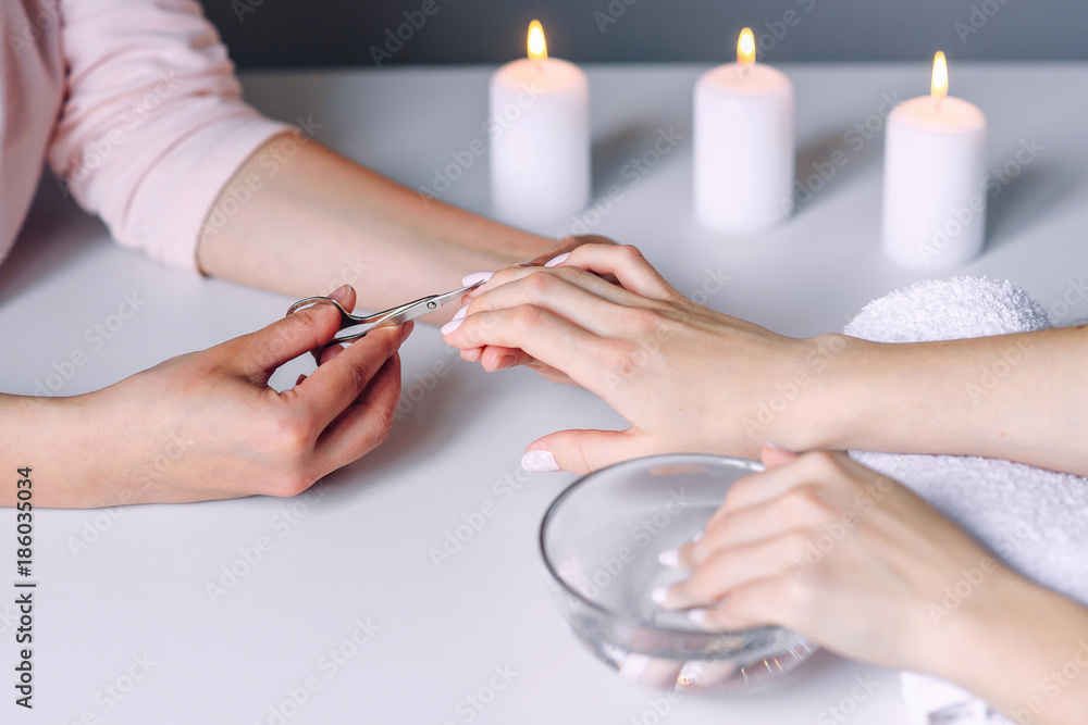 Apply oil to the cuticle. The wound after a manicure. A scratch, a cut.  Manicure, nail care. Nail salon, procedure, SPA. Home nail care. Manicure  tool Stock Photo - Alamy