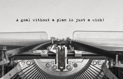 A goal without a plan is just a wish! close up, typed words on a vintage typewriter with vintage background