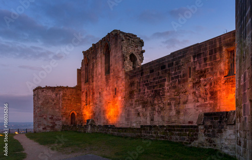 Beautiful sunset on ancient Stafford Castle with colorful sky and light on castle.