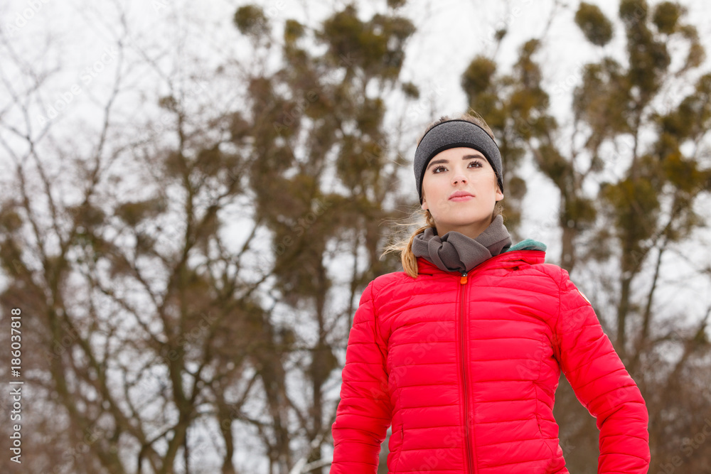 Woman wearing sportswear exercising during winter Woman wearing sportswear exercising during winter