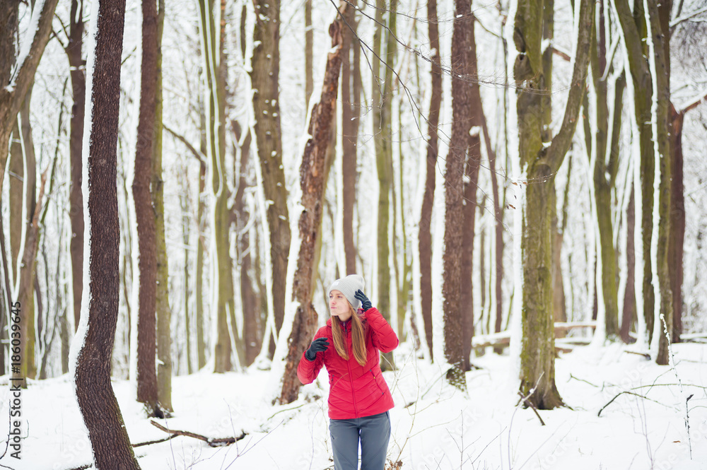 Beautiful girl walking in the winter forest Beautiful girl walking in the winter forest