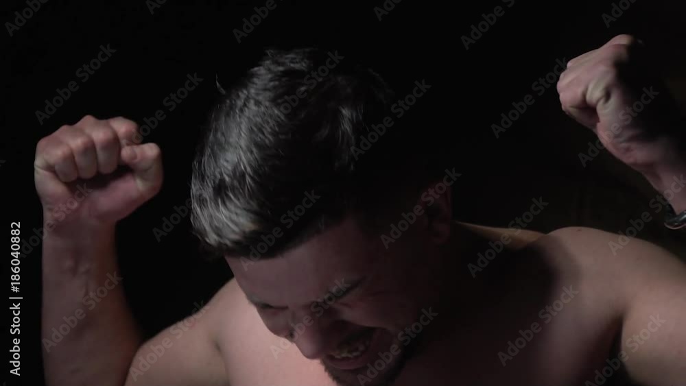 Slow-motion shooting, dark-haired man yelling for joy Slow-motion shooting, dark-haired man yelling for joy