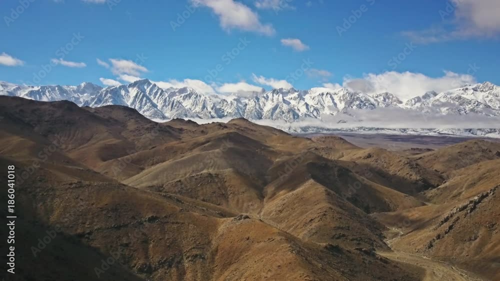 Aerial shot of snow covered mountains in the desert.