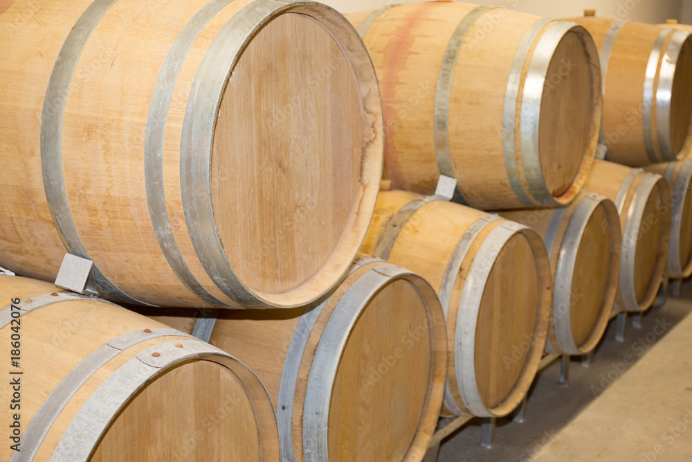 Wine barrels stacked in the cellar winery Wine barrels stacked in the cellar winery