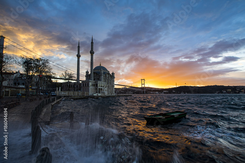 Day to night time lapse scene of the beautiful renovated Ortakoy mosque in Istanbul with Bosphorus bridge in the background.