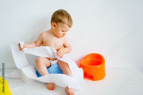 Baby sitting on a potty photo