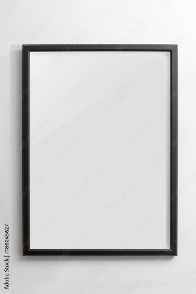 Wooden black empty frame on white wall