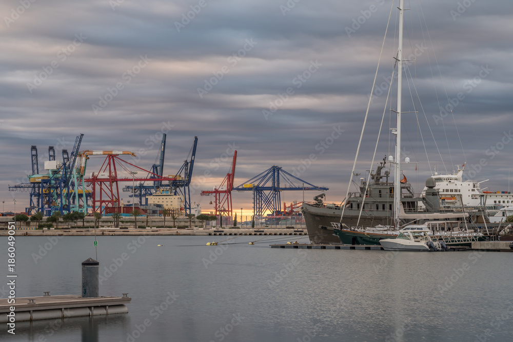 shipping, maritime logistics port harbor cranes working loading transport ships, twilight reflection in water