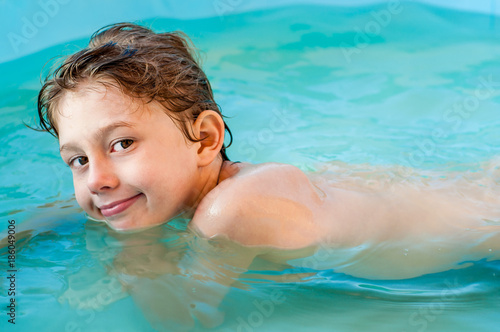 Cute little boy is swimming in the pool