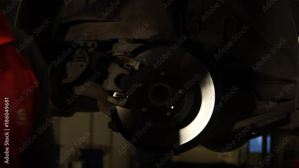 Car service - car mechanic is working on repairing the car. Car service - car mechanic is working on repairing the car.