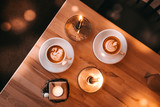 Coffee cups with candle lightings flatlay