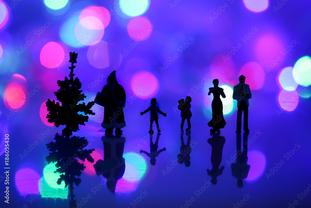 Silhouette of Miniature people: Colorful Christmas characters and decorations with bokeh background . Using as background or wallpaper holiday concept. Silhouette of Miniature people: Colorful Christmas characters and decorations with bokeh background . Using as background or wallpaper holiday concept.