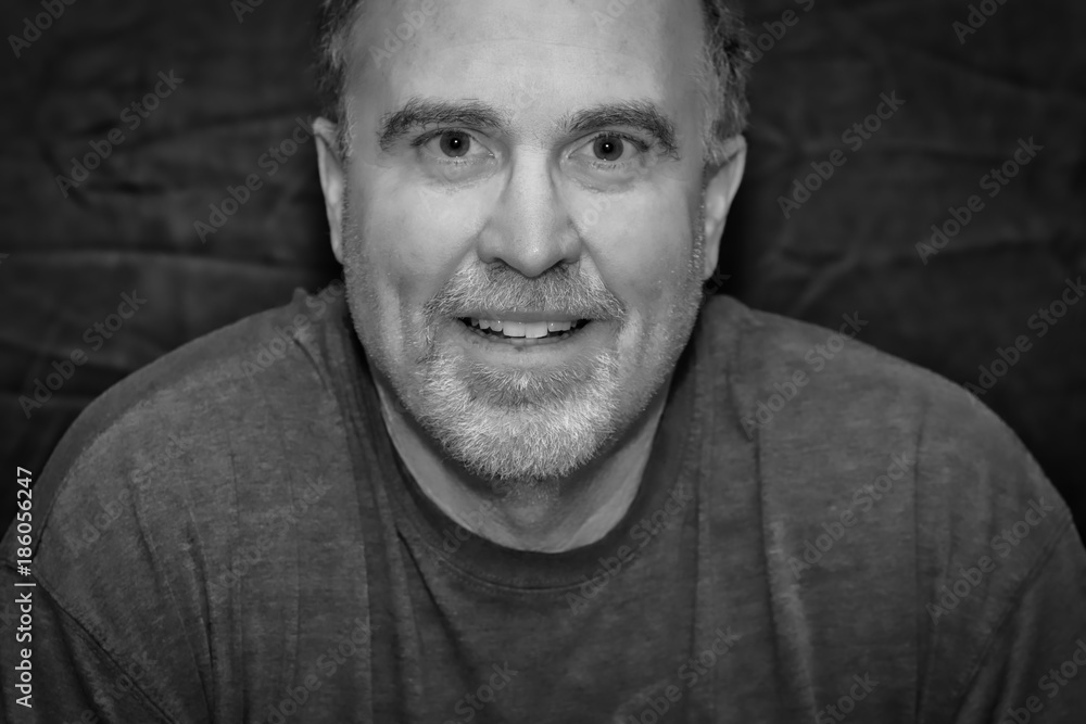 Fototapeta premium Smiling mature man in casual black and white portrait