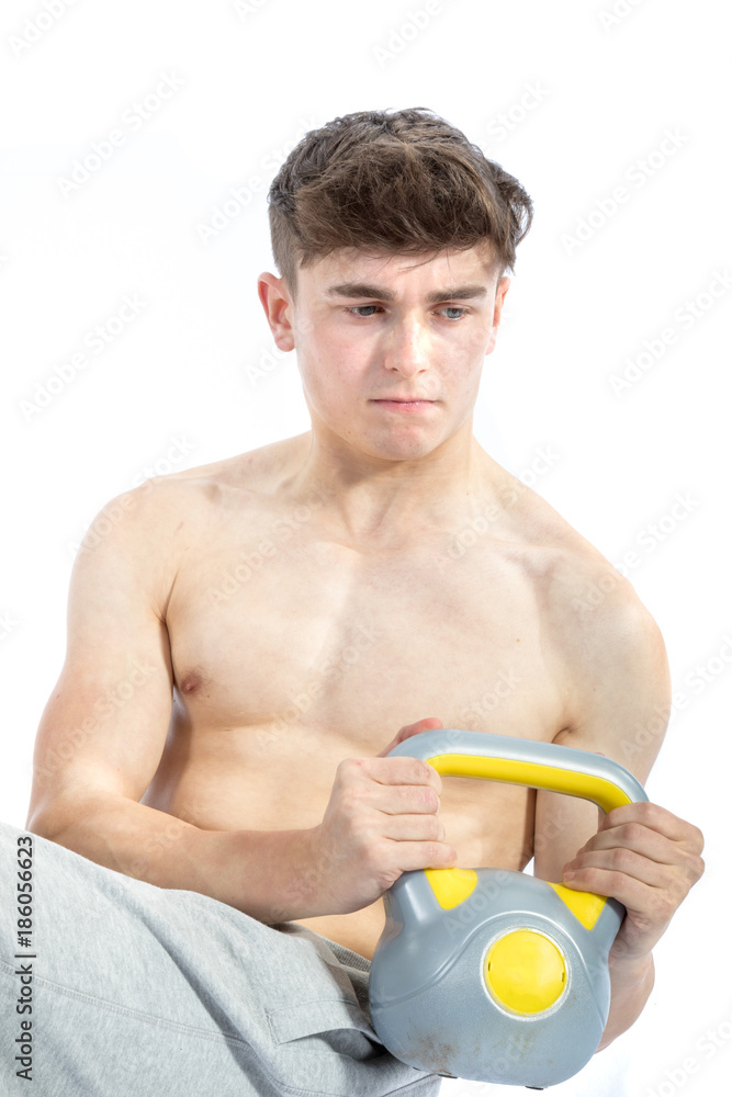 18 Year old teenage boy lifting weights 18 Year old teenage boy lifting weights