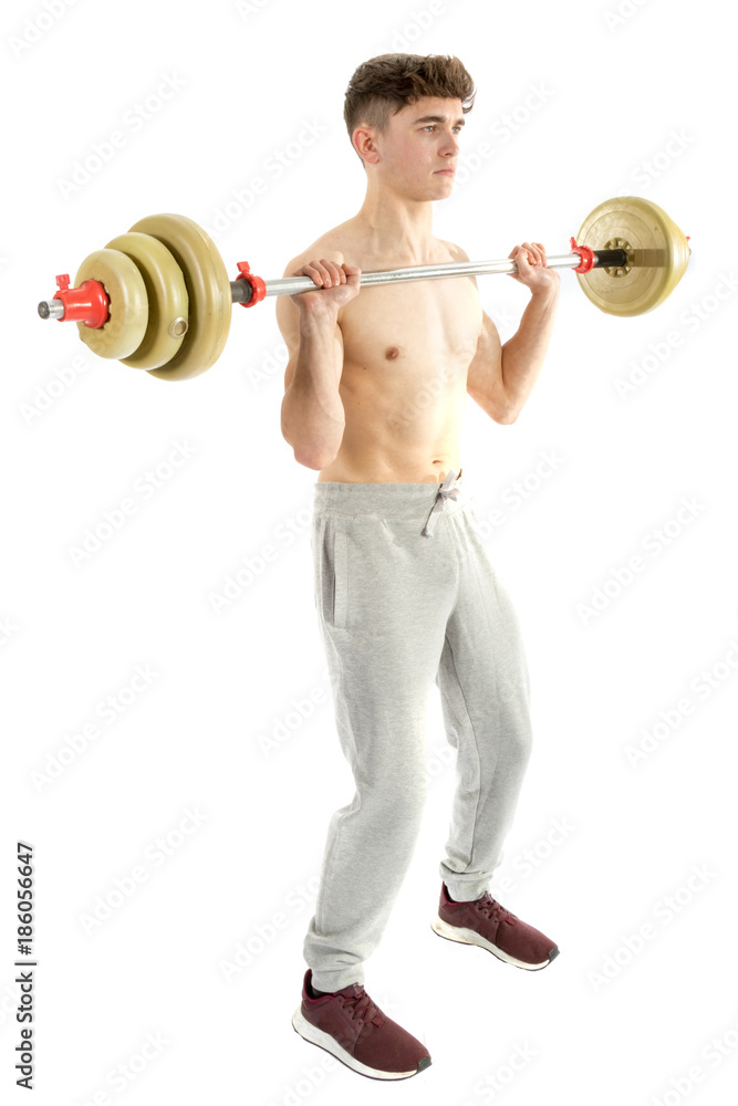 Obraz premium 18 Year old teenage boy lifting weights
