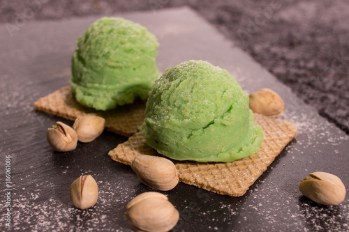 Pistachio ice cream on rustic wooden board