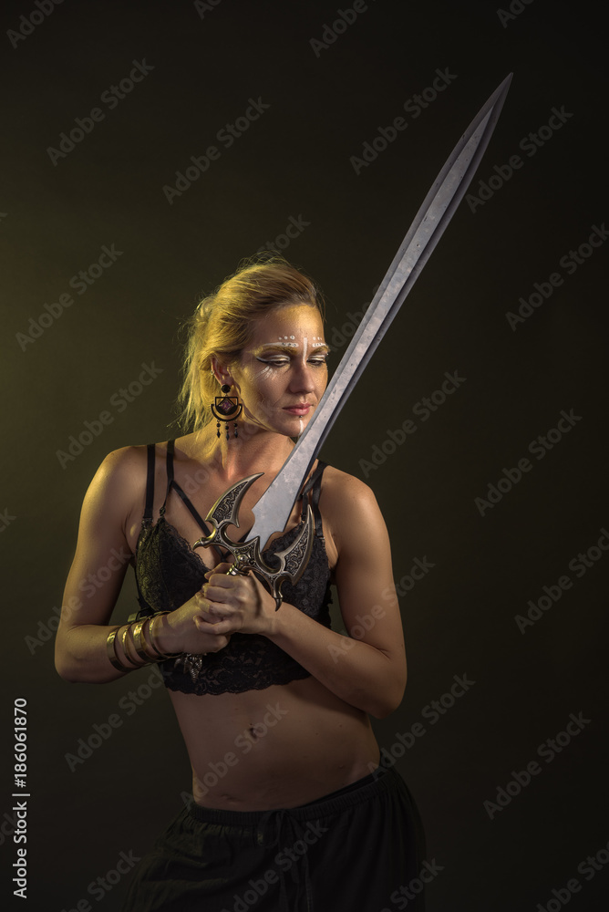 Amazonian woman soldier, fierce fighter wielding a long battle sword
