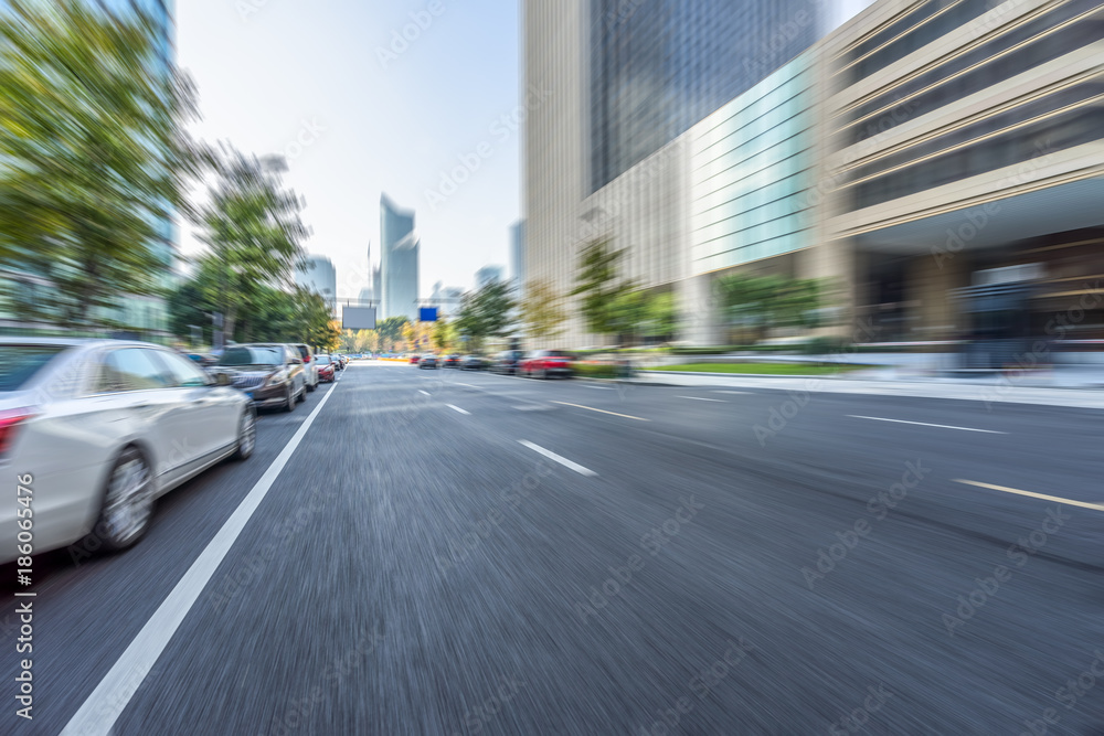 blurred asphalt road through modern city in China blurred asphalt road through modern city in China