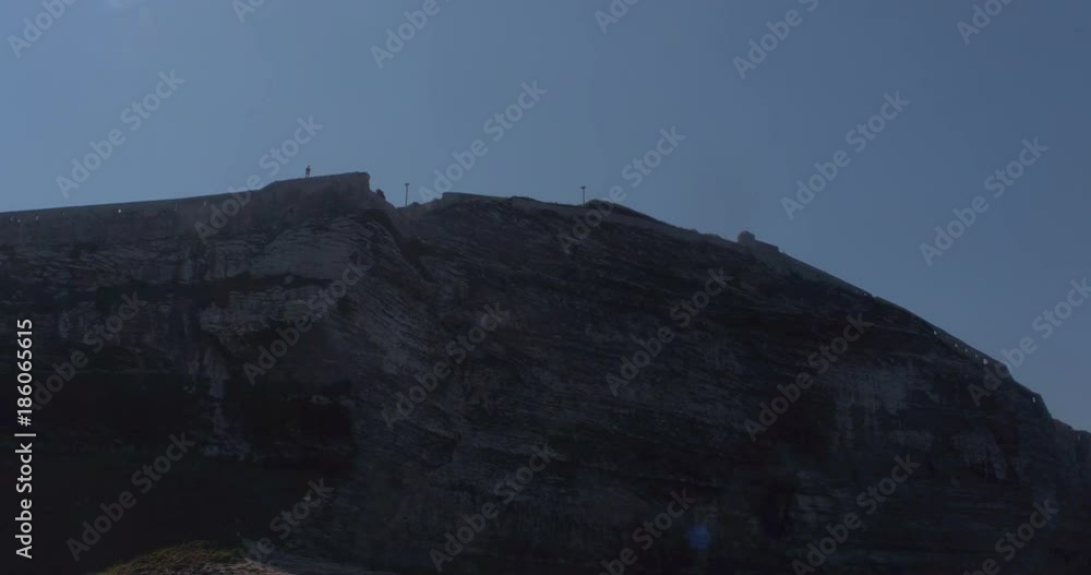 Video shot of Bonifacio city walls on a sunny day with cliffs, sea and blue sky in view Video shot of Bonifacio city walls on a sunny day with cliffs, sea and blue sky in view