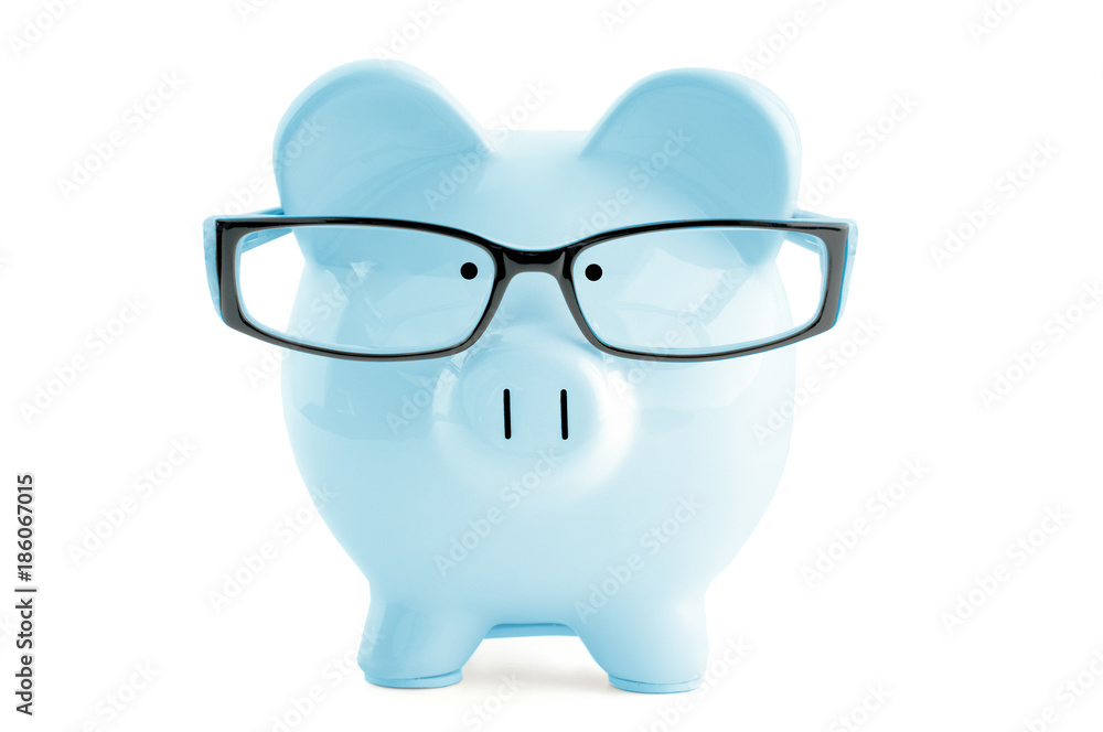 Blue piggy bank in in glasses isolated on white Blue piggy bank in in glasses isolated on white