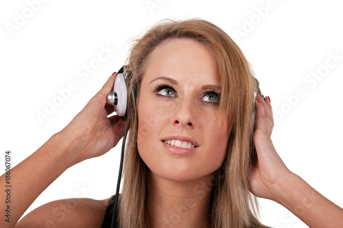 Portrait of a young and gorgeous blonde woman listening music